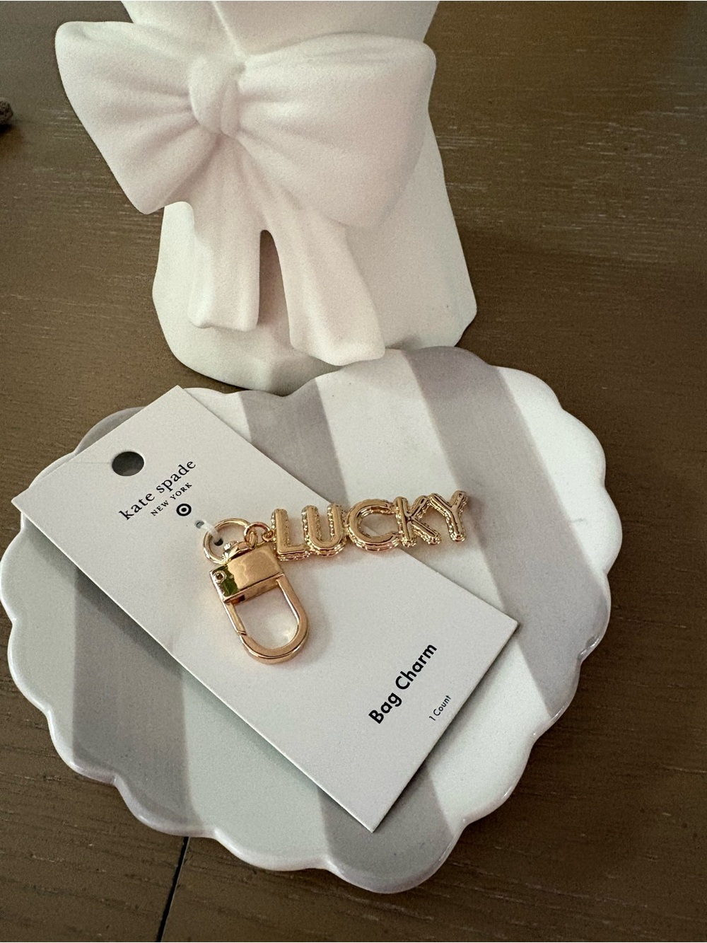 kate spade cream and green retail tag on shell tray